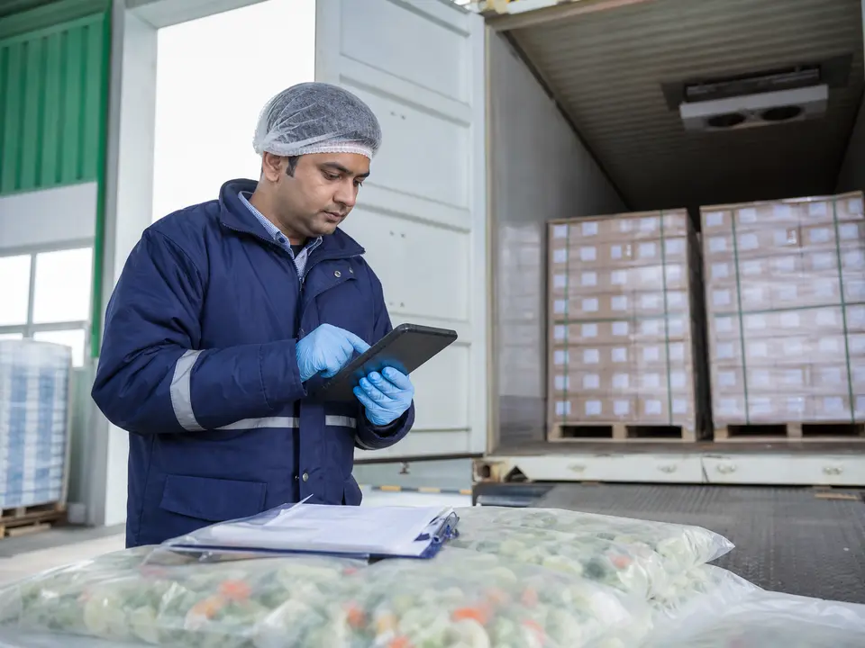 Inspector checking a shipment against a manifest